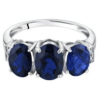Ораво КТ овална форма создаде сина сафир и дијамантски три-камен прстен во 14к бело злато